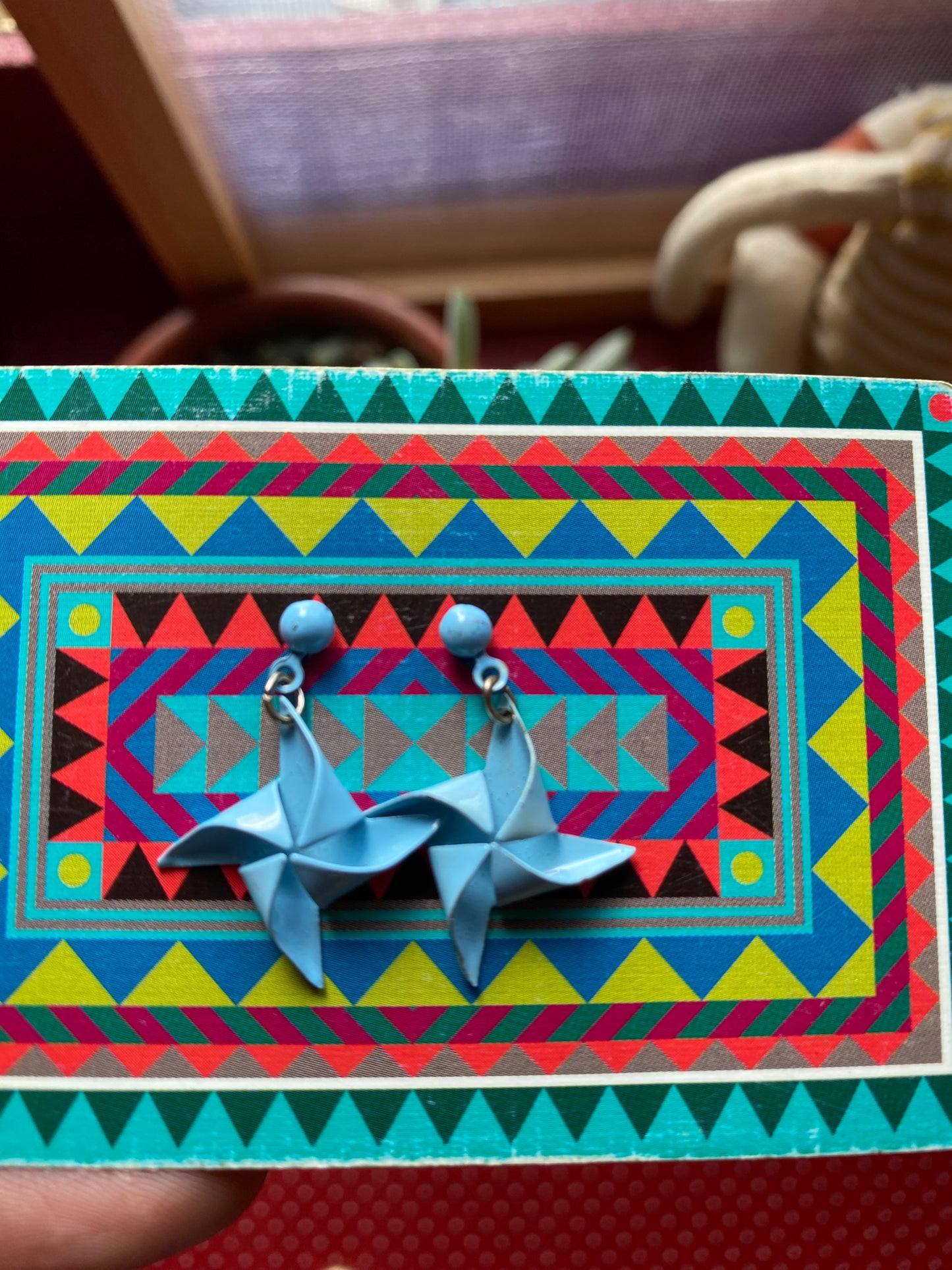 Authentic 80s Blue earrings on a colorful geometric-patterned card