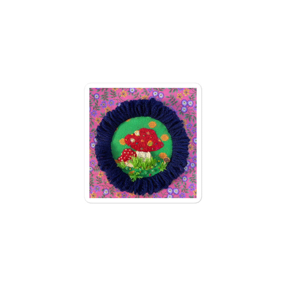 3D hand-embroidered red and white mushroom with colorful dots and grass on hoop