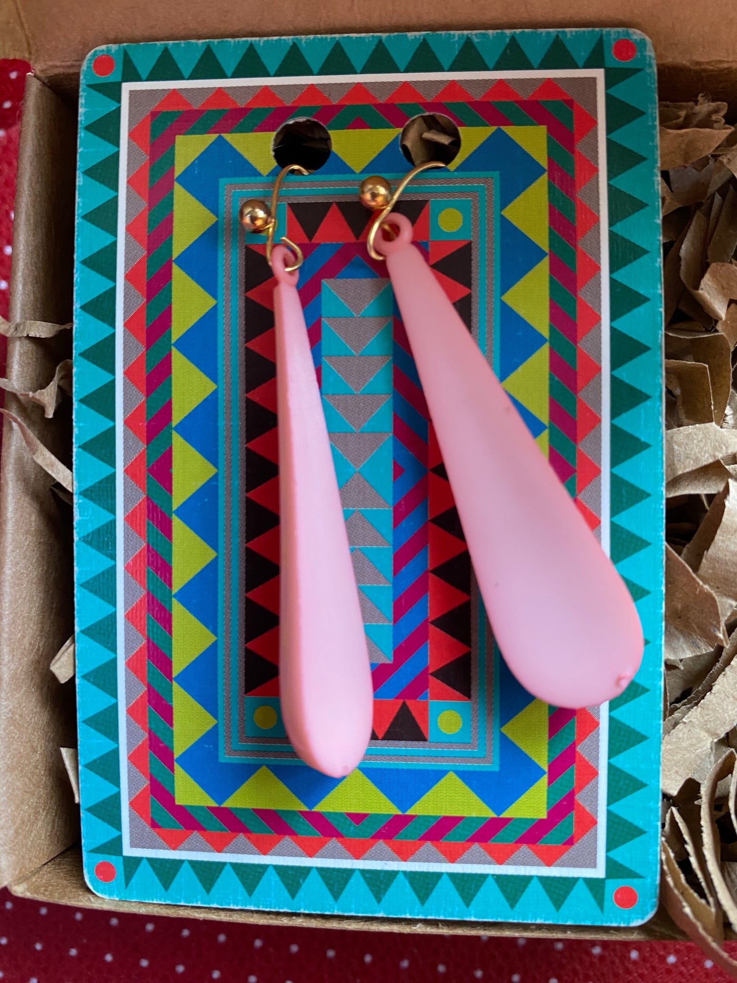 Pink authentic 80s earrings on a colorful geometric-patterned card