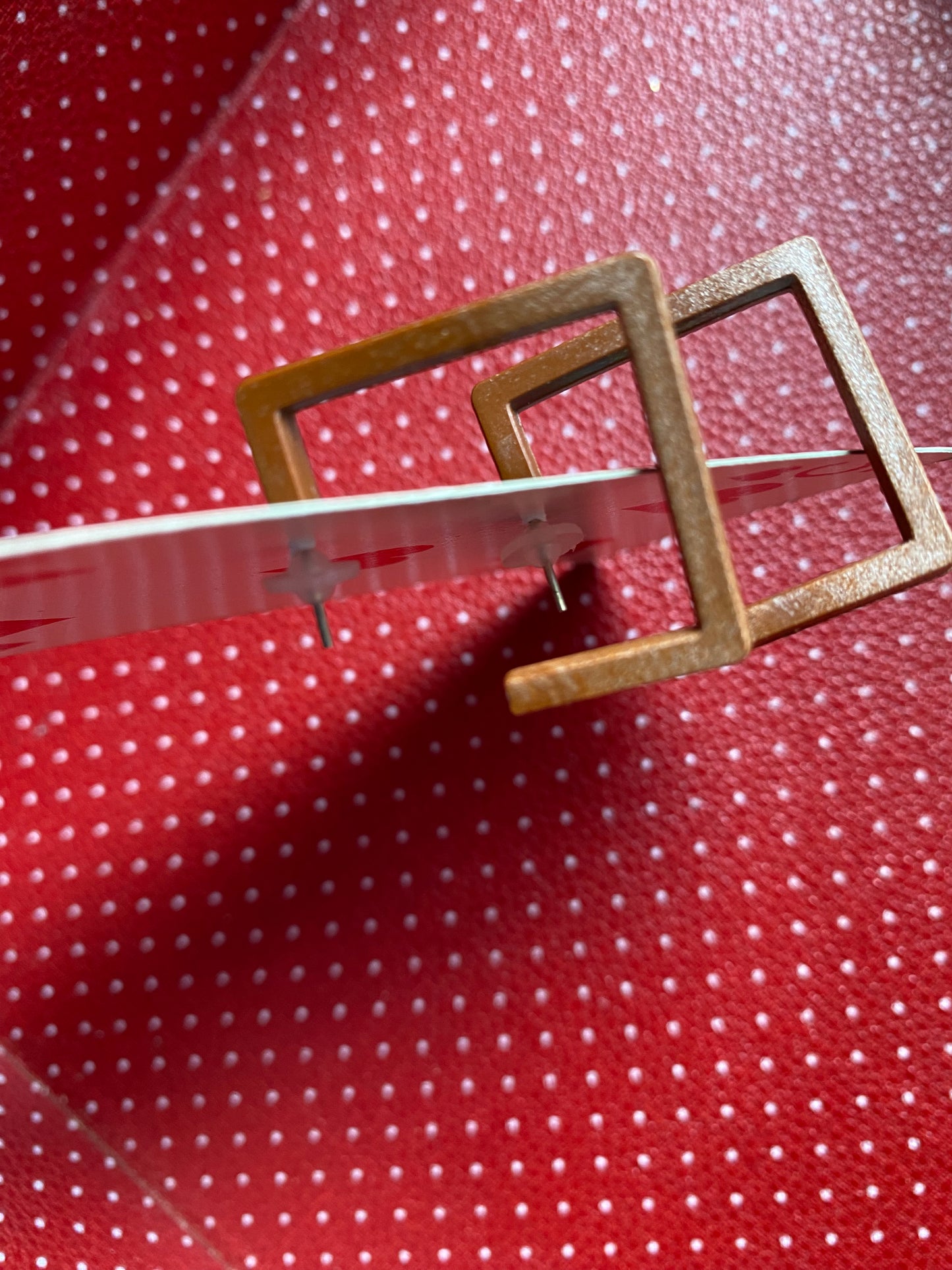 Authentic 80s square earrings on a red retro polka dot background