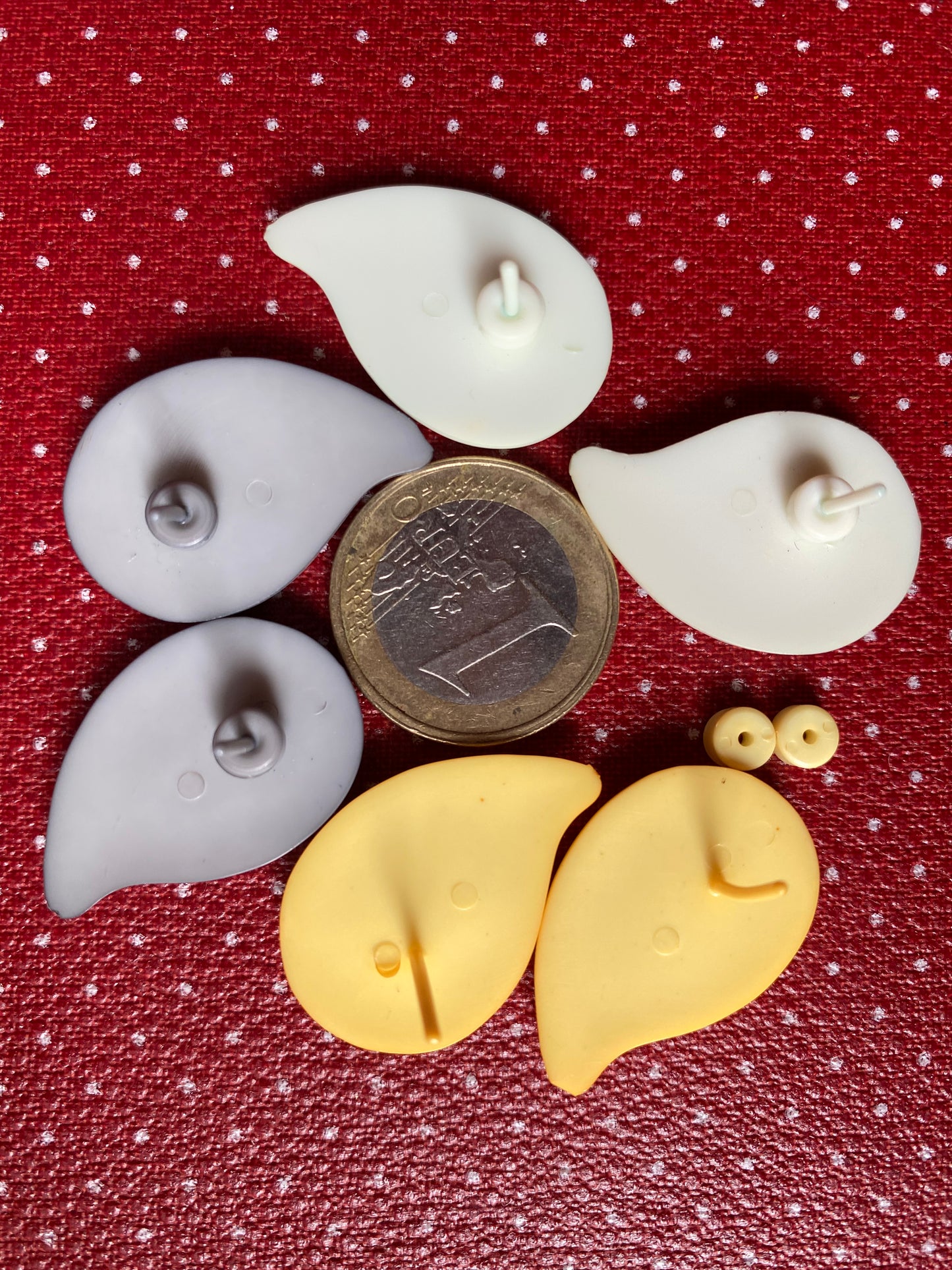 Authentic 80s earrings in yellow, grey & white as the size of a euro coin on a red retro polka dot background