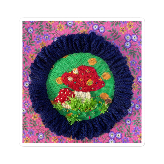 3D hand-embroidered red and white mushroom with colorful dots and grass on hoop
